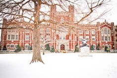 a large building with trees and snow on the ground