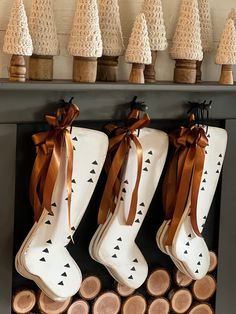 christmas stockings are hung on the mantle with wood slices and pine cones in front of them