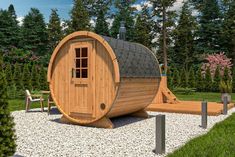 a wooden barrel like structure in the middle of a garden with gravel and rocks around it