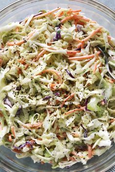 a glass bowl filled with coleslaw and carrots