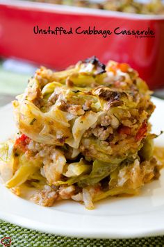 a plate with some food on it and a red casserole dish in the background