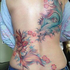 a woman's stomach with colorful tattoos on it