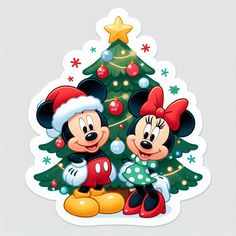 two mickey and minnie mouse characters standing next to a christmas tree