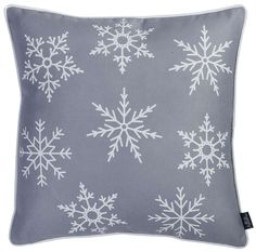 a grey and white pillow with snowflakes on it