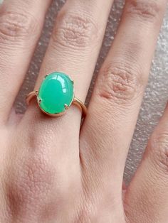 Chrysoprase ring in 10 carat yellow gold, quality green Chrysoprase ring, oval cabochon Chrysoprase ring The Chrysoprase measures 14x10mms and weighs 5.4 carats The ring is in 10 carat yellow gold Ring size is M (Australian size) or 7 1/4 (US size). Ring is ready to ship in 1-2 working days.  We resize free of charge.  Please allow a couple of additional days for resizing. All my rings come in a velvet ring box.  I am highly conscious of environmental damage that extra packaging can create so my Green Oval Opal Ring, Elegant Green Opal Oval Ring, Yellow Gold Emerald Chrysoprase Cabochon Ring, Classic Green Opal Cabochon Ring, Elegant Green Opal Ring Oval Cabochon, Elegant Green Opal Ring With Oval Cabochon, Classic Green Oval Opal Ring, Classic Green Cabochon Emerald Ring, Green Oval Opal Ring For Formal Occasions