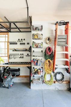 a garage filled with lots of different types of tools and equipment on the wall next to each other