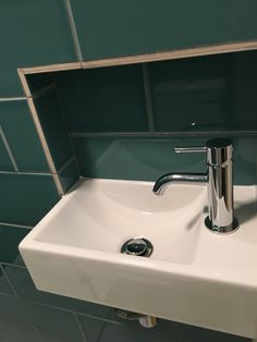 a bathroom sink with a chrome faucet and soap dispenser on it