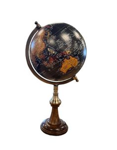 an antique globe on a wooden stand against a white background