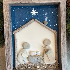 a nativity scene in a wooden frame