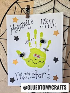 a handprinted sign with the words mommy's little monster on it and stars