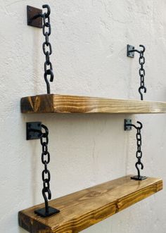 two wooden shelves with chains hanging from them