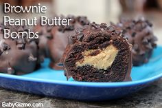 chocolate cupcakes with peanut butter frosting are on a blue plate and there is the bite taken out