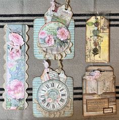 there are four tags with flowers on them and one has a clock in the middle