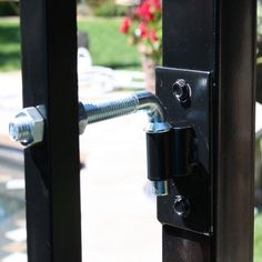 an open door with a black handle and bolt on the outside part of the door