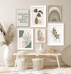 a white table topped with lots of pictures and vases next to a potted plant