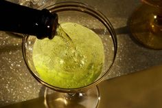 a glass filled with liquid sitting on top of a counter