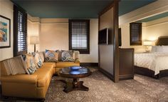 a living room filled with furniture next to a bed