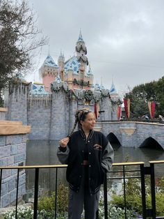 a woman standing in front of a castle