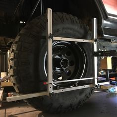 there is a large tire on the back of a truck that is being worked on