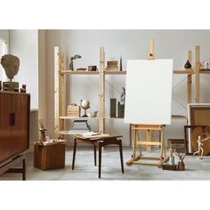 an artist's easel and other art supplies in a studio