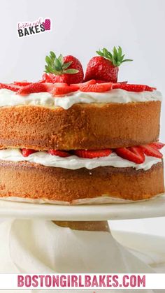 a cake with white frosting and strawberries on top