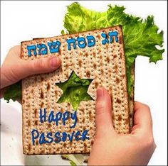 two hands holding a cracker with happy passover written on it and lettuce