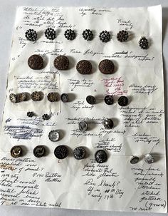 a bunch of buttons are sitting on a piece of paper