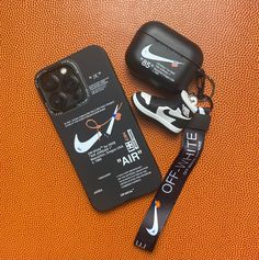 a pair of nike air force sneakers next to an off - white phone case and lanyard