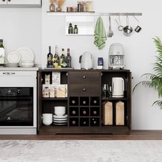 a kitchen area with an oven, microwave and other items on the counter top in front of a potted plant