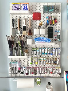 a peg board with lots of craft supplies on it