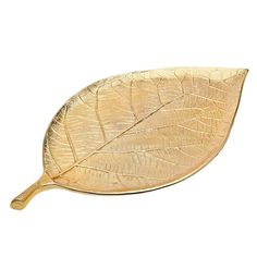 a golden leaf shaped object on a white background