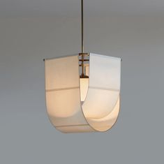 a white light hanging from a ceiling in a room with gray walls and flooring