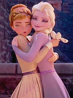 two dolls are hugging each other in front of a castle