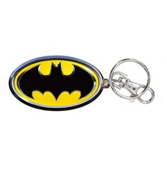 a batman keychain is shown with the symbol on it's front and back