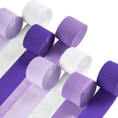 several rolls of purple and white toilet paper