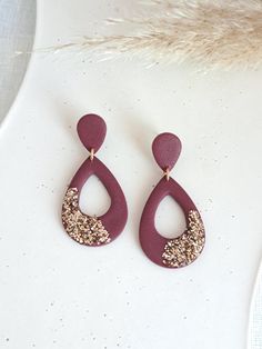 Burgundy Polymer Clay Earrings: These teardrop-shaped dangle earrings are crafted from polymer clay in a rich emerald green embellished with gold glitter accents, and finished with 18k gold-plated posts. Handmade and lightweight, these earrings are perfect for adding a touch of elegance to any New Year's celebration or holiday occasion. They make a unique and thoughtful gift for her, blending rustic charm with a touch of sparkle! MATERIAL: 18K Gold Plated posts (Hypoallergenic, safe for sensitive skin). SIZE: 1.77 in (4.5 cm) PROCESSING TIME: The time that I need to prepare your order varies, but will be within what is stated on the item. PACKING: All items are sent in a beautiful and eco friendly packaging, with the gift of a beautiful handmade heart (see last photo), perfect to send dire New Year Clay Earrings, Glitter Clay Earrings, New Years Clay Earrings, Elegant Polymer Clay Earrings, New Years Jewelry, Handmade Clay Jewelry, Thoughtful Gifts For Her, Earrings Teardrop, Eco Friendly Packaging