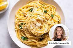 a white bowl filled with pasta next to lemons and a photo of gita de laurentii