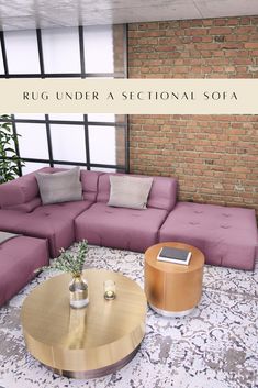 a living room filled with purple couches next to a brick wall