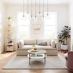 a living room with two couches and a coffee table in front of a window