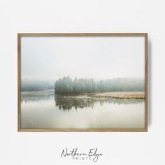 an image of a lake with trees in the background and foggy sky above it