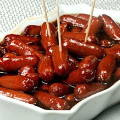 hotdogs with toothpicks in a white dish