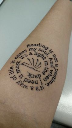 a person with a tattoo on their arm that reads reading is my soul and life