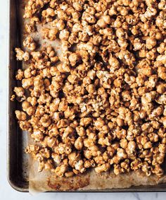 a pan filled with caramel popcorn on top of a counter