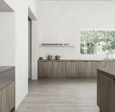 an empty kitchen with wooden cabinets and counter tops