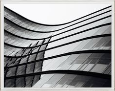 an abstract photograph of the side of a building with wavy lines in black and white