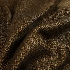 a close up view of a brown and black fabric with an interesting pattern on it