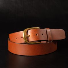 Handmade in our Toronto studio, Liora is a beautiful, tan full-grain leather belt that features a gold, rounded buckle. It can be worn as a waist belt around a dress or a regular belt around some high rise jeans. Crafted with meticulous attention to detail, Liora’s tan leather ages gracefully, developing a unique patina over time. The name "Liora" means light and indeed this belt shines bright as the centrepiece of any outfit. One solid piece of full grain leather. No bonded belts, period. This Brown Leather Belt With Brass Hardware, Classic Leather Belt Buckles With Gold-tone Hardware, Classic Hand-tooled Leather Belt, Modern Leather Belts With Gold-tone Hardware, Black Leather Belt With Gold-tone Hardware, Tan Leather Belt, Aging Gracefully, Suspender Belt, High Rise Jeans