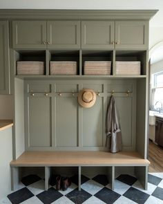 a coat rack with baskets and hats on it in the entryway to a home