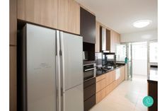 a modern kitchen with stainless steel appliances and wood cabinets