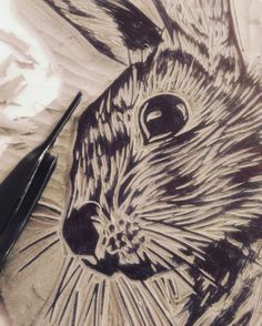 a drawing of a rabbit on paper next to a pen